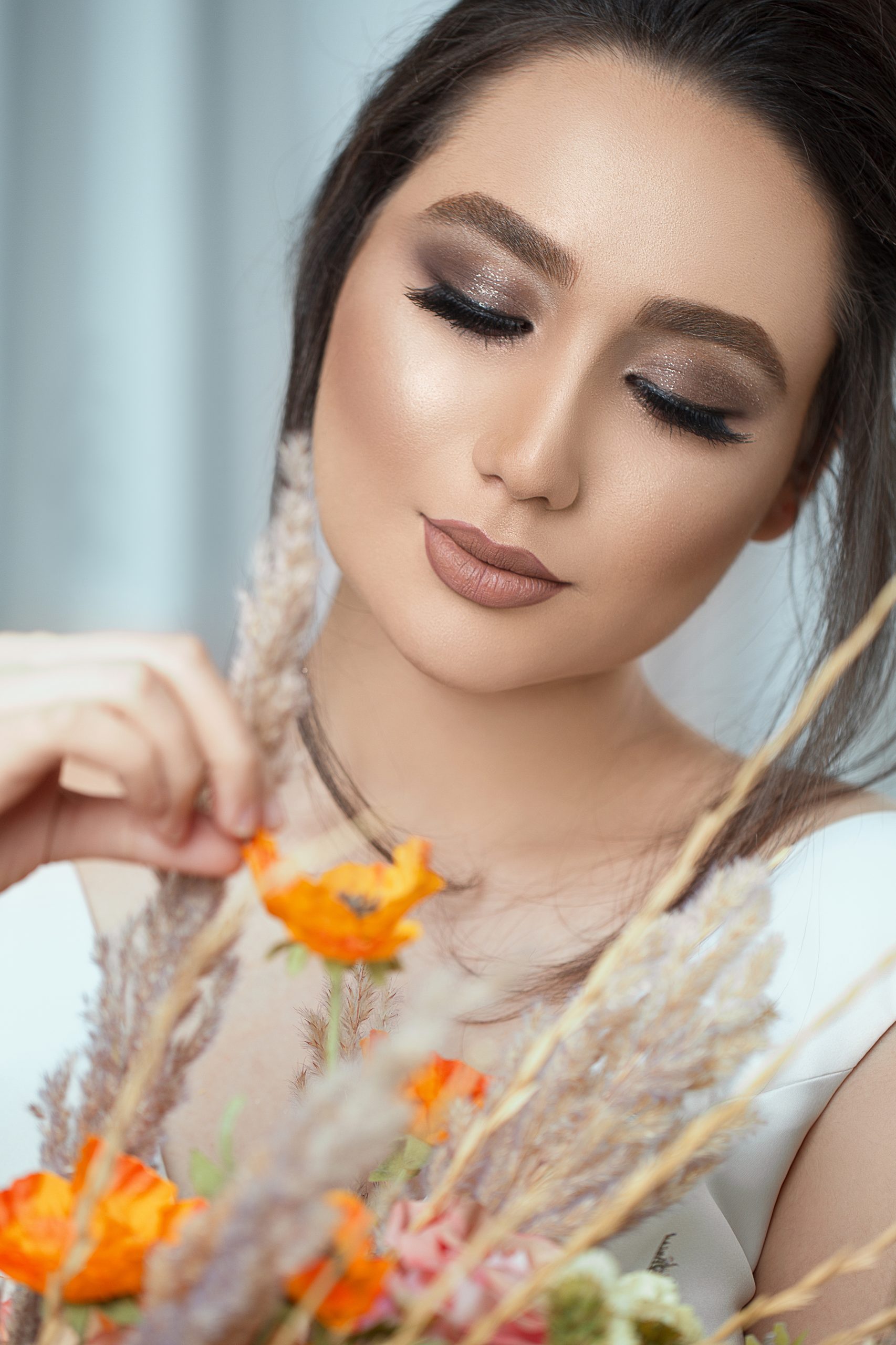 Model in light makeup holding spring flowers